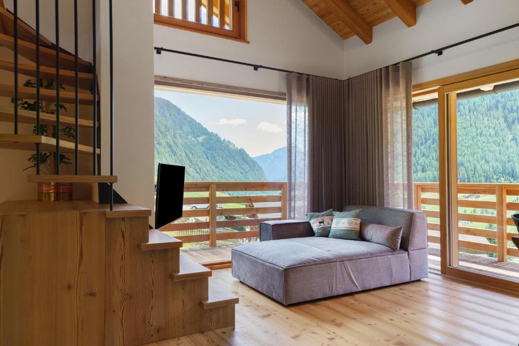 a living room with a couch and a large window at Mas de la Tata in Rabbi