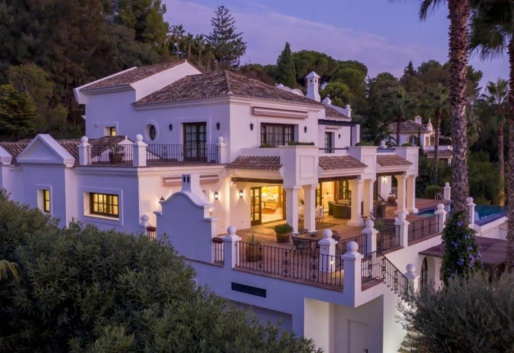 a large white house with a balcony at Villa Sildavia in Estepona