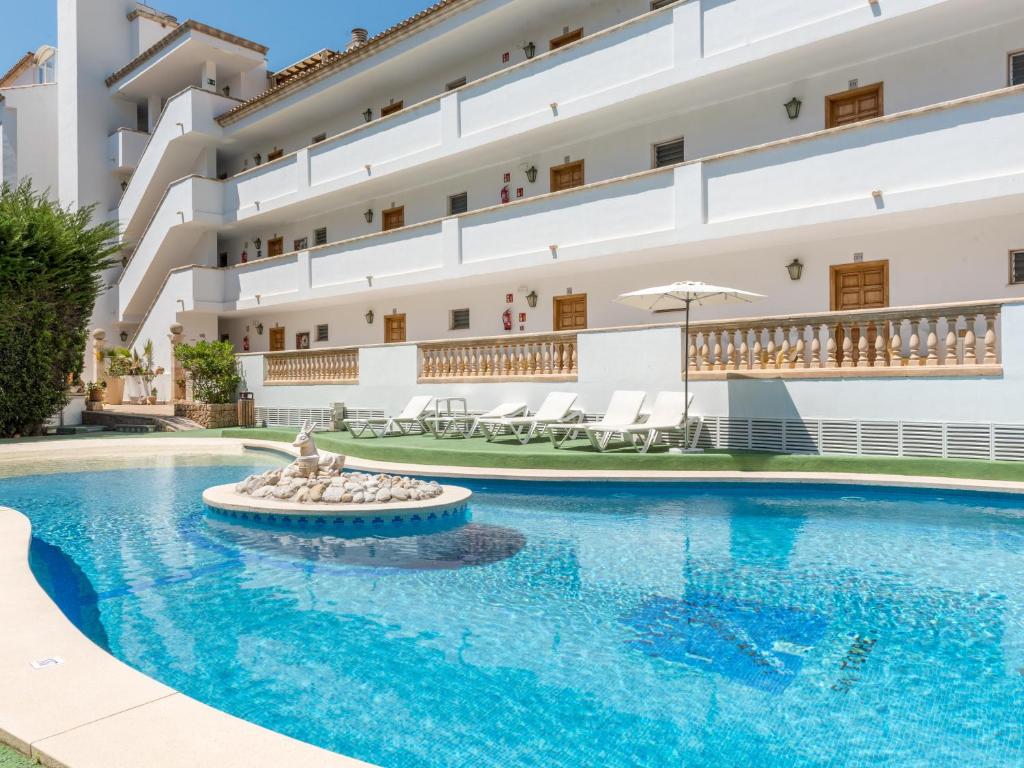 a swimming pool in front of a building at Sa Torre iii in Canyamel