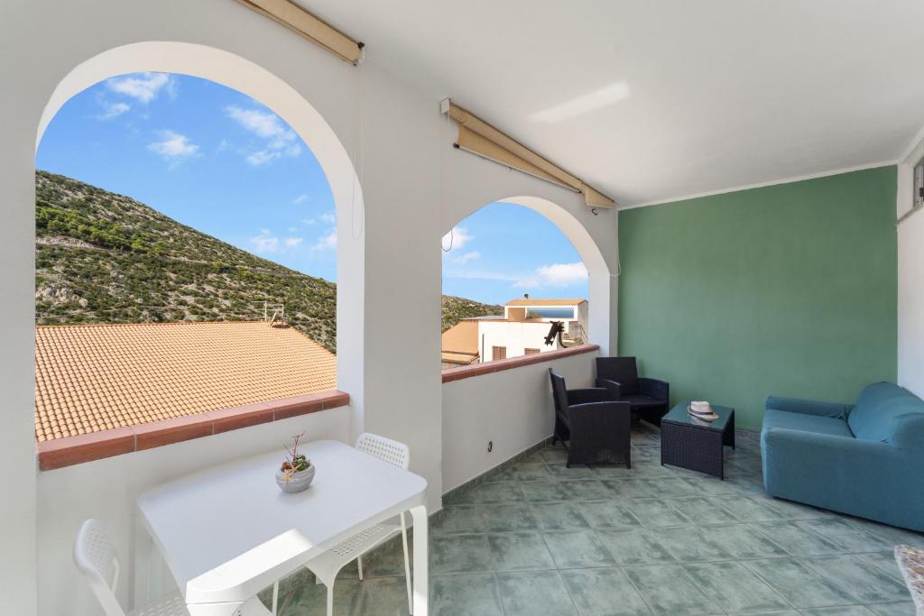 a living room with a view of a mountain at Buggerru Hugo House in Buggerru