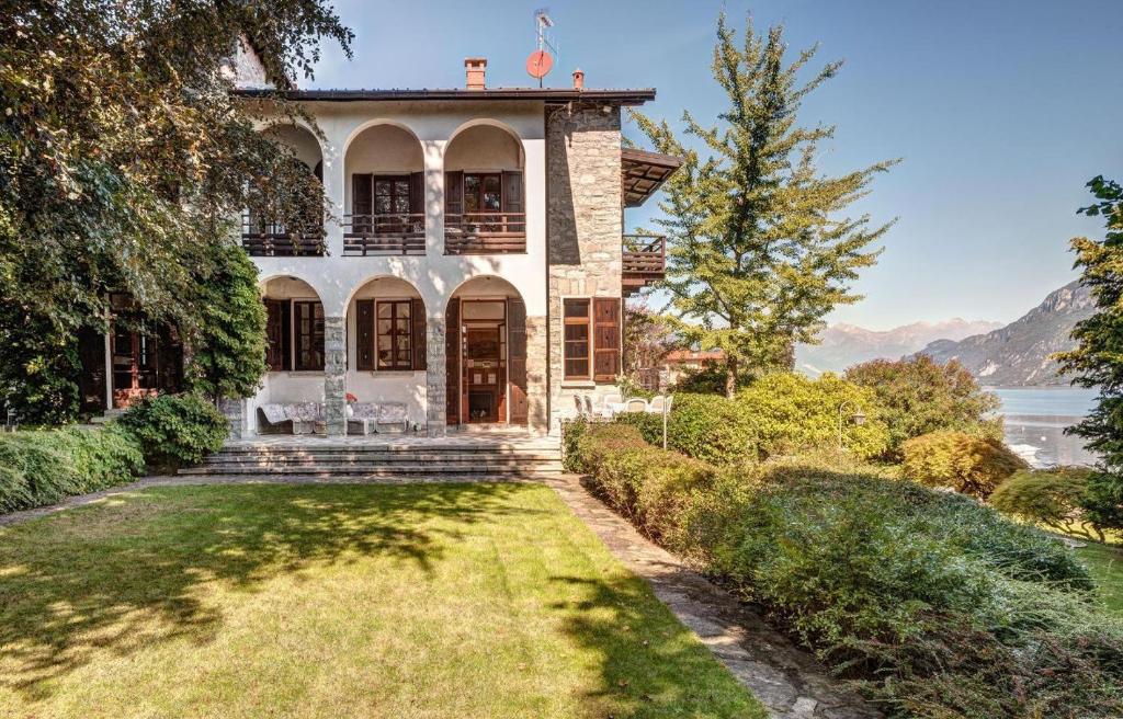 a house with a view of the water at Villa Il Cigno Lakeside in Oliveto Lario