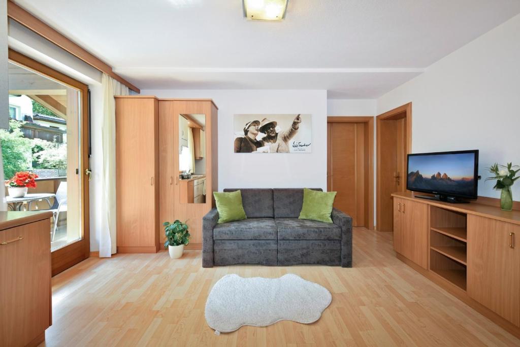 a living room with a couch and a television at Alpenchalet Niederkofler Isabella in San Giovanni in Val Aurina