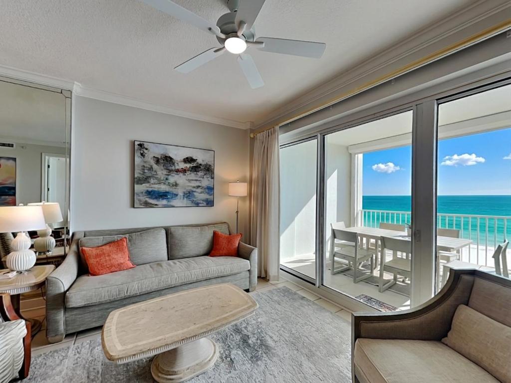 a living room with a couch and a view of the ocean at Regency Isle #609 in Orange Beach