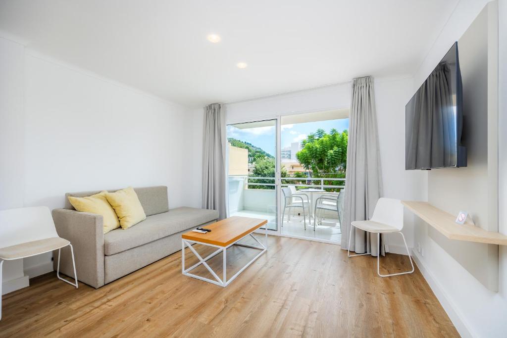 a living room with a couch and a table at Apartament Massanet 1b in Canyamel