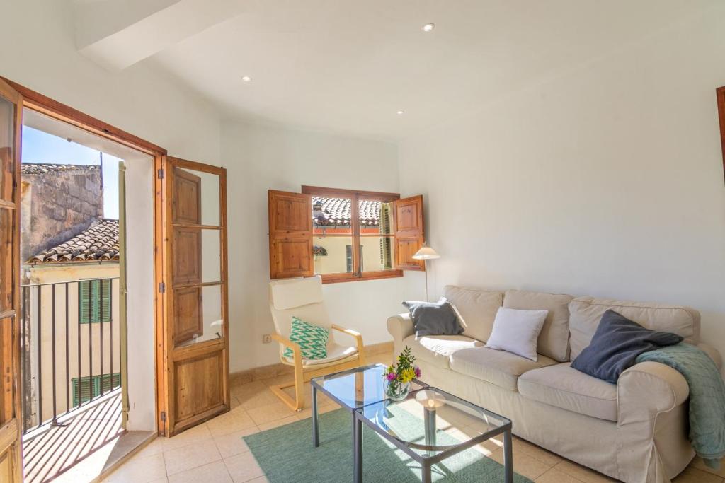 a living room with a couch and a glass table at Maca Sol in Campanet
