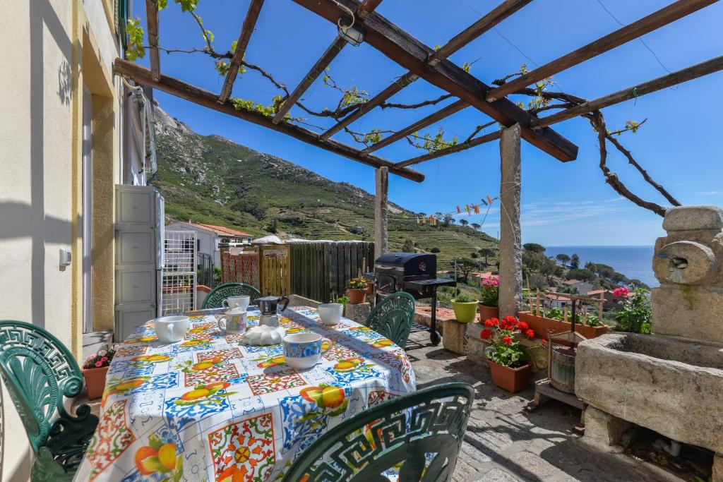 a table on a patio with a view of the ocean at Casa Ebaté in Chiessi