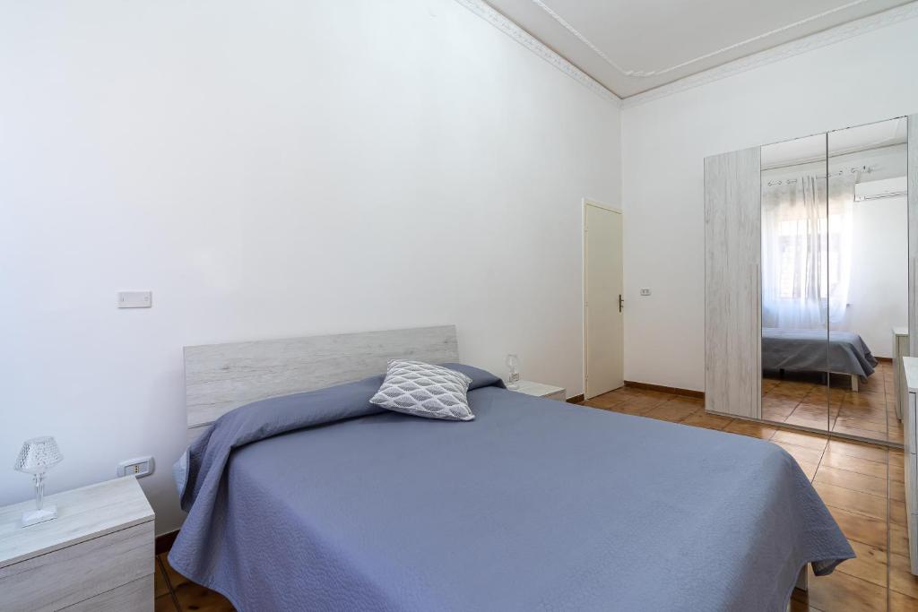 a bedroom with a bed with a blue blanket at Ciuri Ciuri in Avola