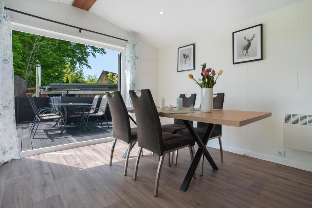 a dining room with a table and a piano at Haus Waldblick in Saal