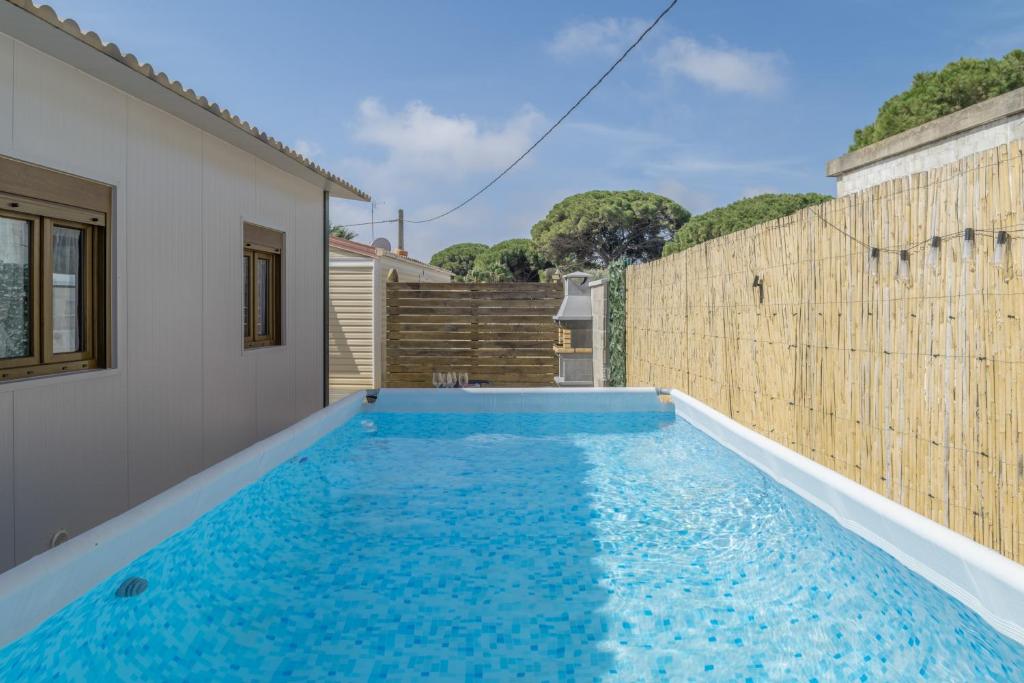 a swimming pool in the backyard of a house at Casa Sofia in Conil de la Frontera