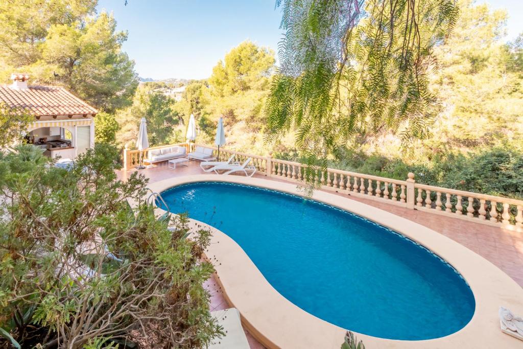 an overhead view of a swimming pool with a fence and trees at Fantastisic villa - Great location in Moraira