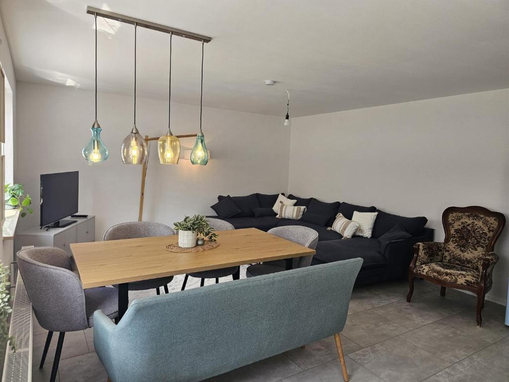 a living room with a table and a couch at Haus Alb-Apfel in Apfelstetten