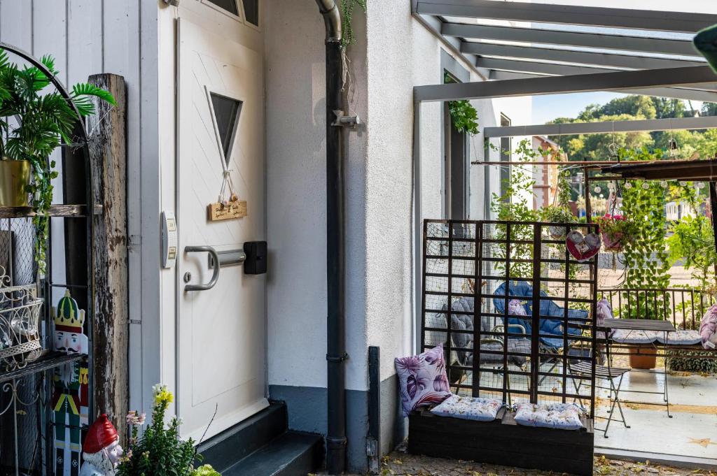 a front door of a house with a chair on the porch at Ferienappartments Nähe Schweiz in Kandern
