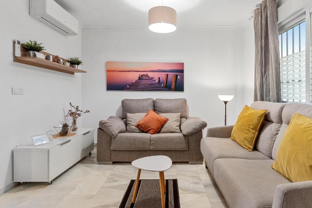 a living room with a couch and a table at Malvarrosa A103 in Fuengirola