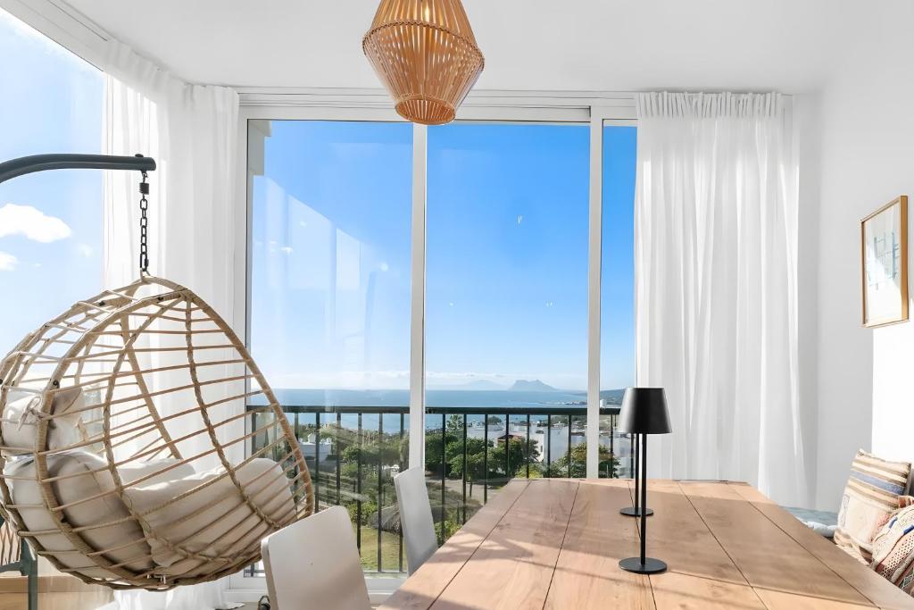 a dining room with a table and a large window at Casa Maria Luisa in Manilva