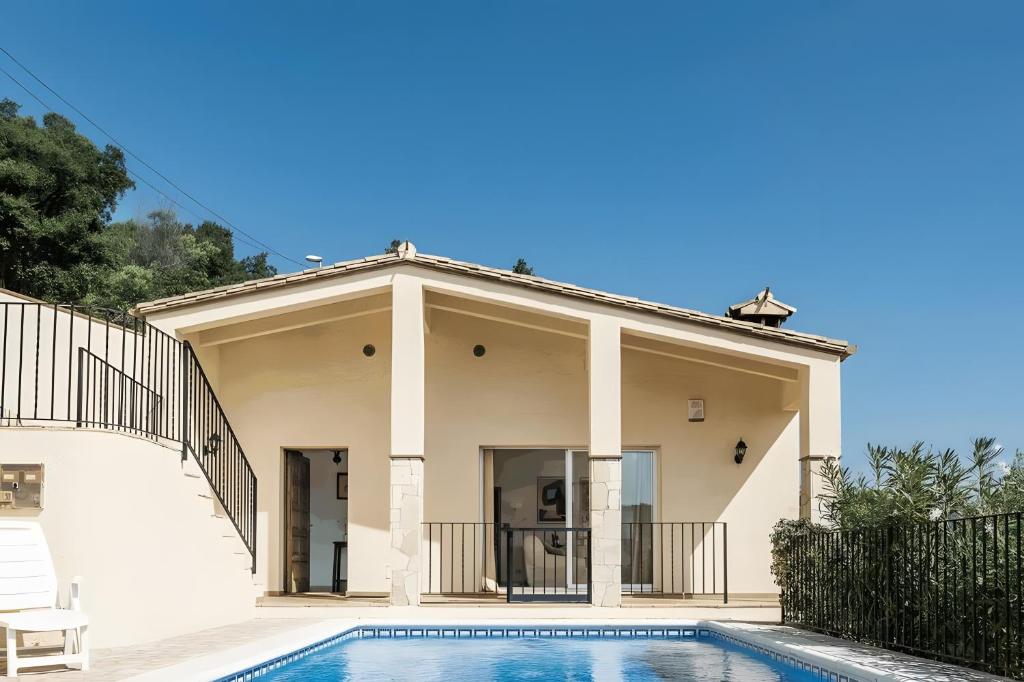 a house with a swimming pool in front of it at Villa Granvista by Easy Brava in Calonge