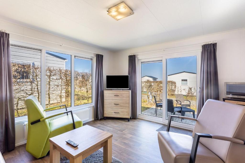 a living room with a couch and a tv at Chalet 91 in Brilon