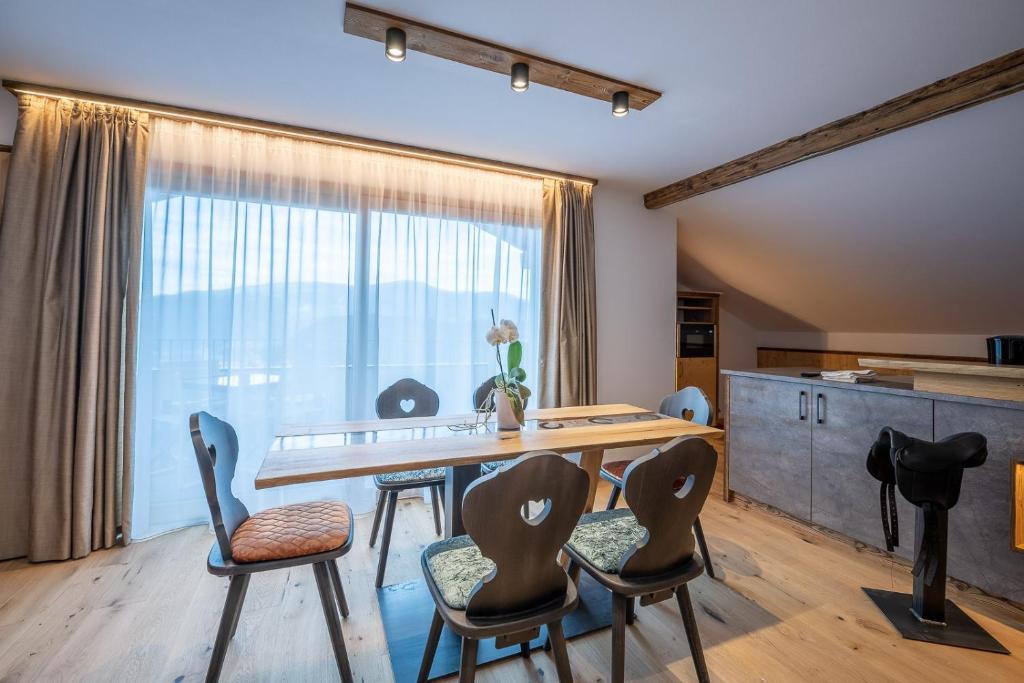 a dining room with a table and chairs at Ladinser Hof Western Suite in Castelrotto