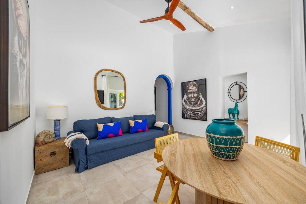 a living room with a blue couch and a table at Blue Sardine Historic Townhouse Algarve Beaches in Portimão
