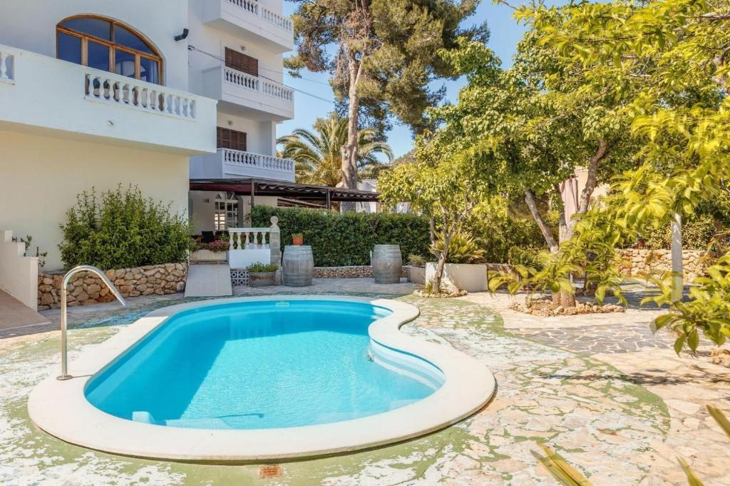 a swimming pool in the yard of a house at Apartamento La Cabanya 2a in Canyamel