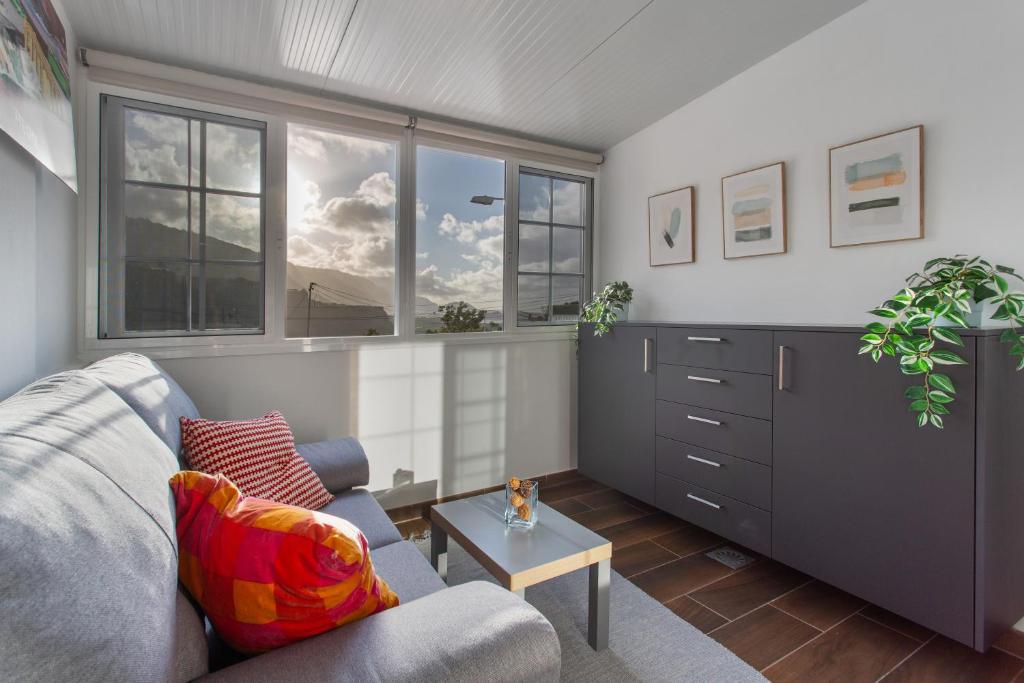 a living room with a couch and a table at Sea and Sunset Love in San Marcos