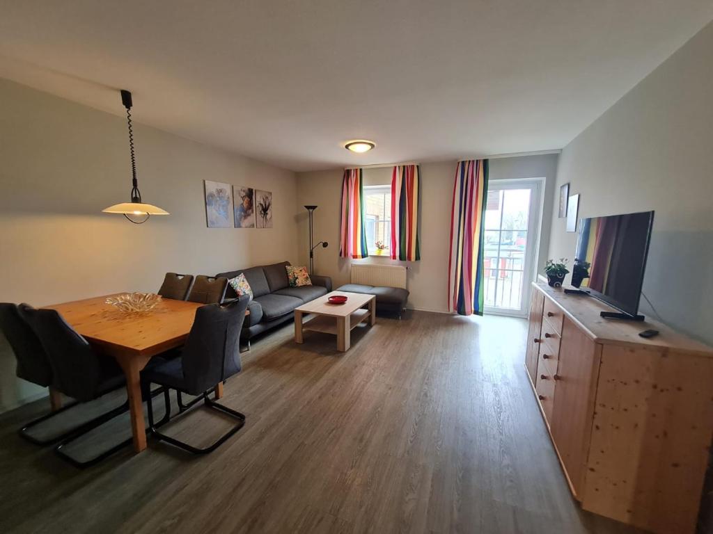 a living room with a couch and a table with a dining room at Orth A4 in Orth