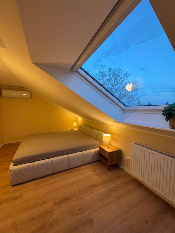 a bedroom with a bed and a large window at Apartment Oben in der Heide in Faßberg