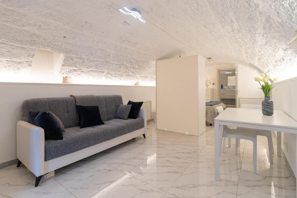 a living room with a couch and a table at La Porta Sul Mare- Timone in Mola di Bari
