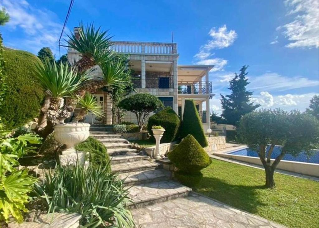 a house with a garden with trees and plants at Villa Maja in Sutomore