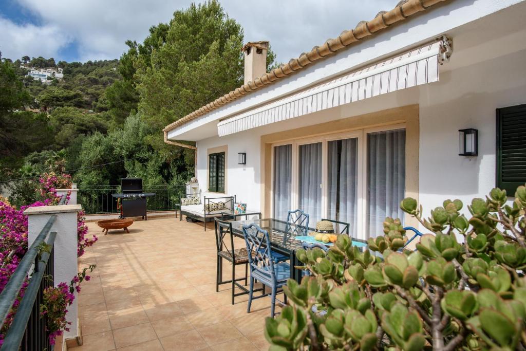 a patio of a house with chairs and a table at Villa Polina in Capdepera