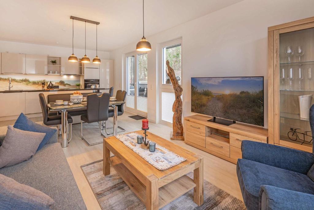 a living room with a couch and a table at FeWo Lieblingsort in Loddin