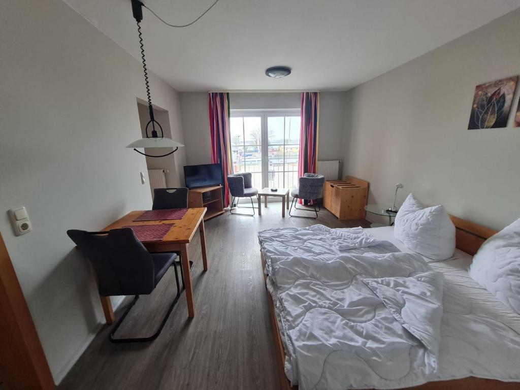 a bedroom with a bed and a desk and a table at Orth A5 in Orth