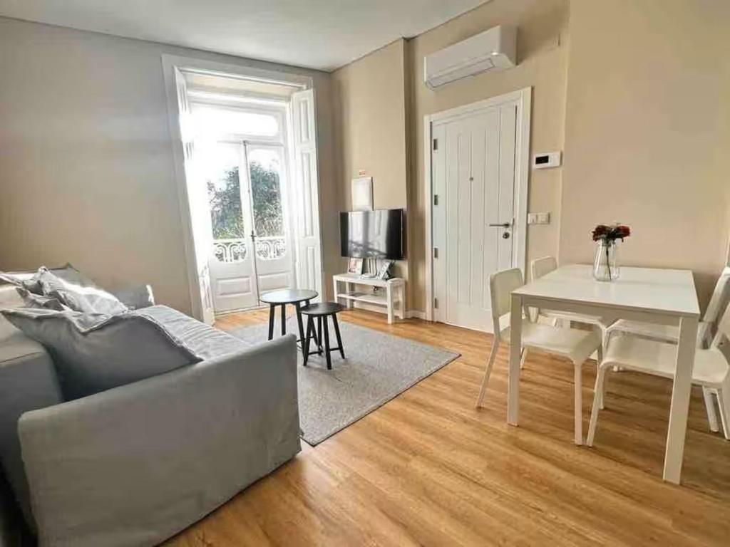 a living room with a couch and a table at Setubal Prime, By Home Match in Setúbal