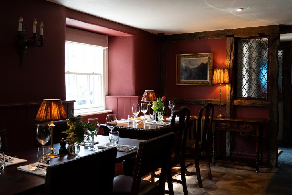 a dining room with tables and chairs with wine glasses at The King's Arms in Hawkshead