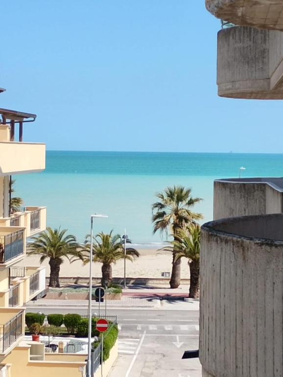 a view of the beach from the balcony of a building at On the Beach in Tortoreto Lido