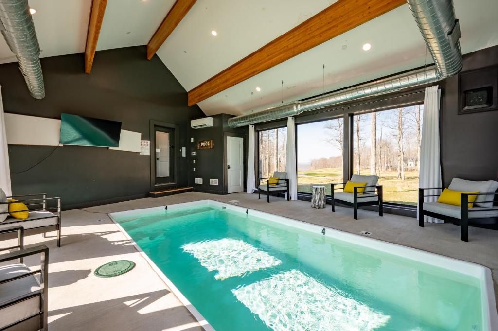 a swimming pool in a house with a room with windows at Sunset On The Greens by Railey Vacations in McHenry