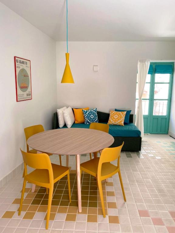 a living room with a table and chairs and a couch at Cefalhub in Cefalù