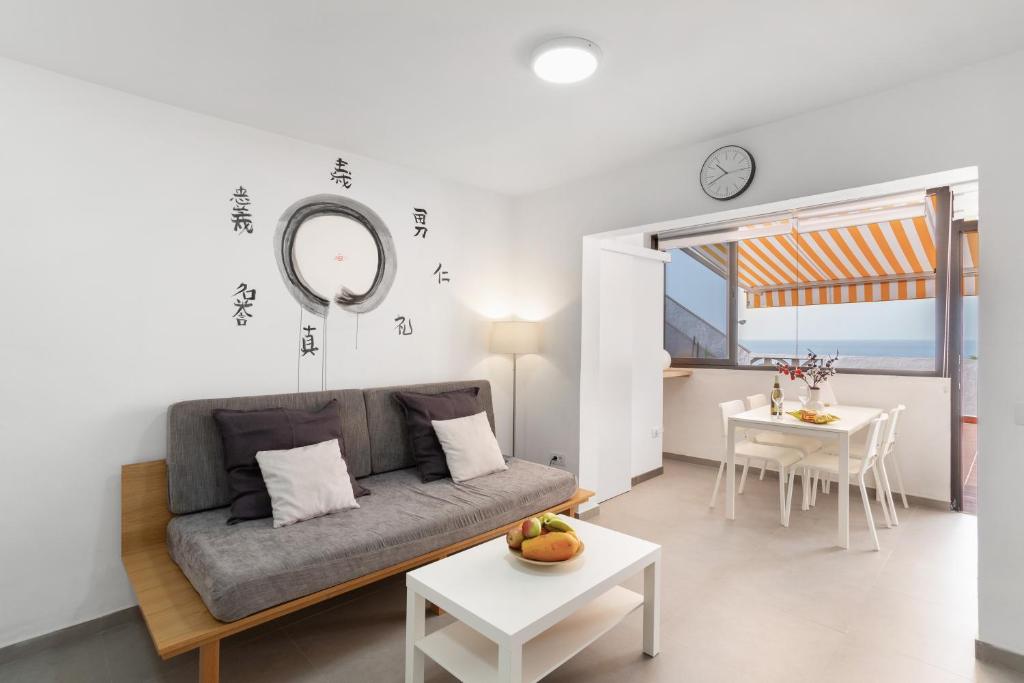 a living room with a couch and a table at Casa Isabel eccezionale Vista Mare in Mogán
