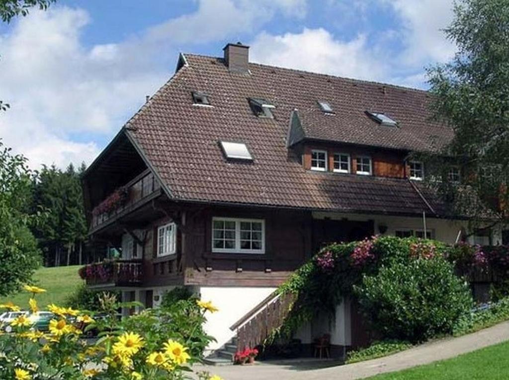 a large house with flowers in front of it at Landeckhof in Oberwolfach