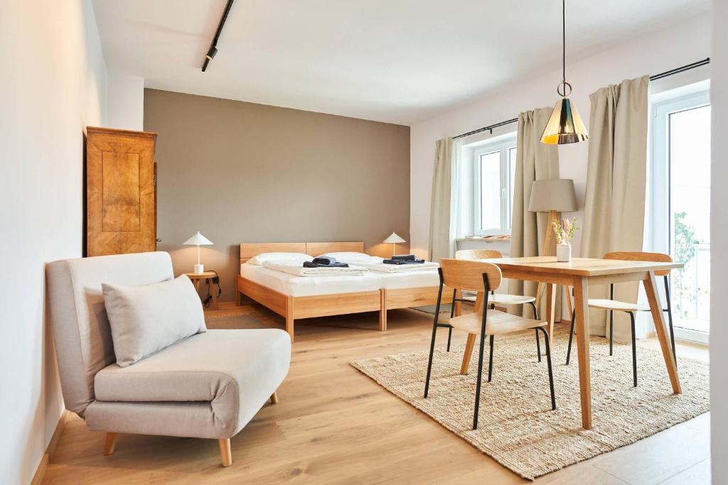 a room with a bed and a table and a bedroom at Alte Seifensiederei - Thay in Bad Tölz