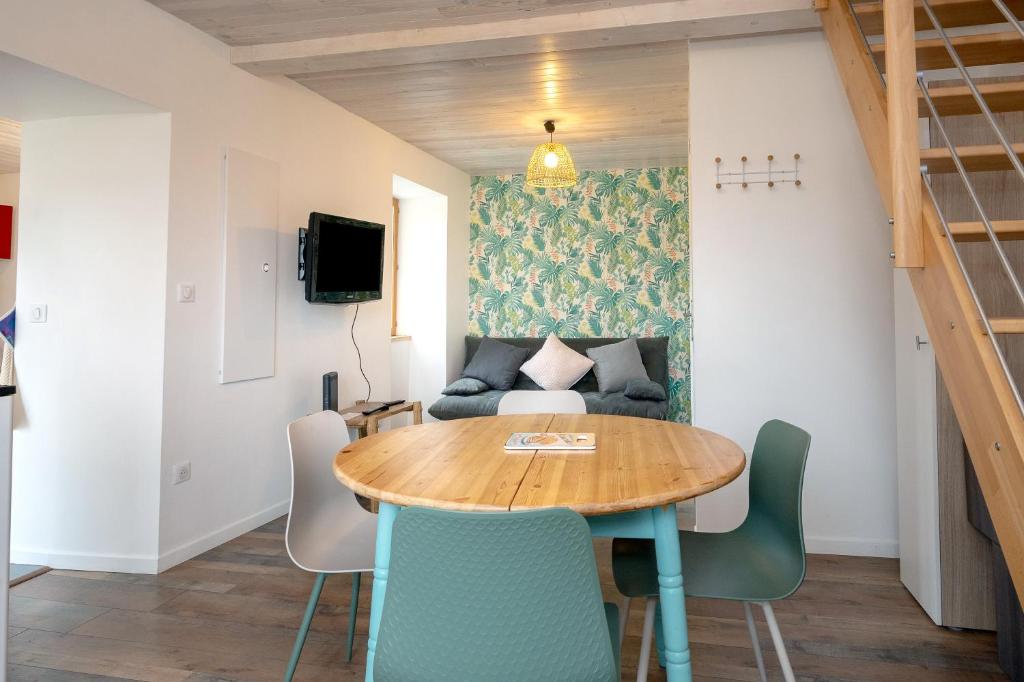 a living room with a table and a couch at Chez Pierre et Germaine in Saint-Maurice-de-Rotherens