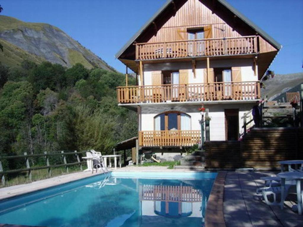 a house with a swimming pool in front of a house at Appartement n°8 - 5 personnes in Saint-Sorlin-dʼArves