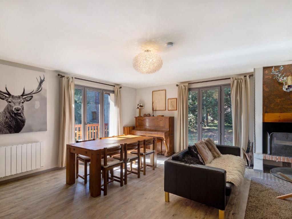 a living room with a dining room table and a couch at Chalet Lilette in Font-Romeu-Odeillo-Via