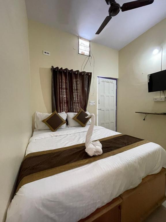a bedroom with a large bed with a swan on it at Casablis homestay in Mysore