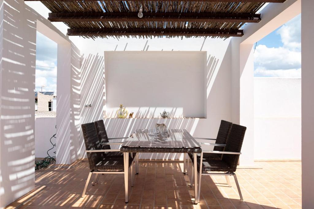 a dining room with a table and chairs at Villa Canijo in Barbate