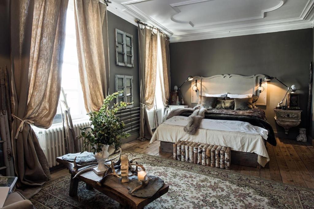 a bedroom with a bed and a large window at L Annexe d Aubrac in Aubrac