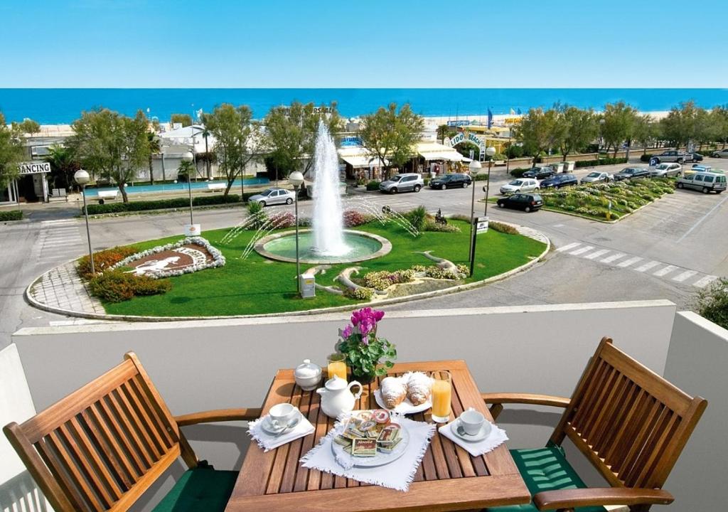 a table with a plate of food and a fountain at Hotel Genzianella in Cervia
