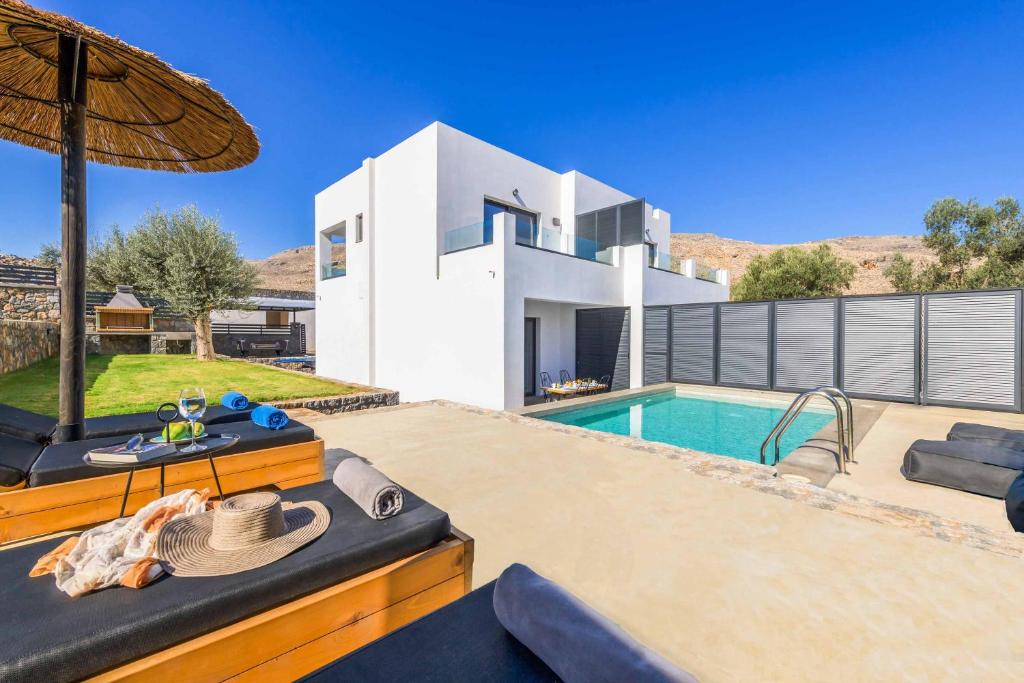 a villa with a swimming pool and a house at Lambis Athina in Lindos
