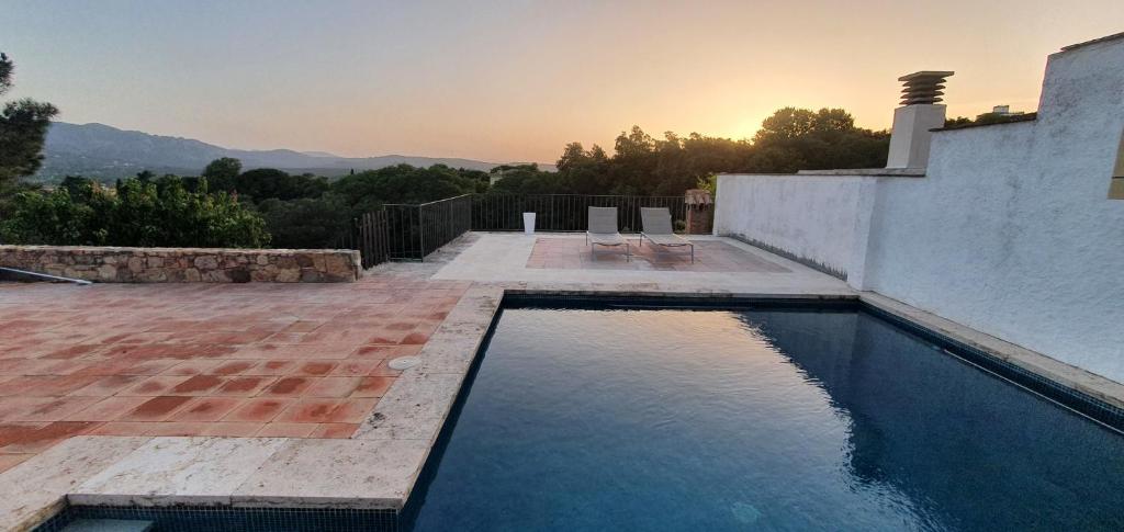 a swimming pool on the side of a house at Can Tarana in Santa Cristina d'Aro