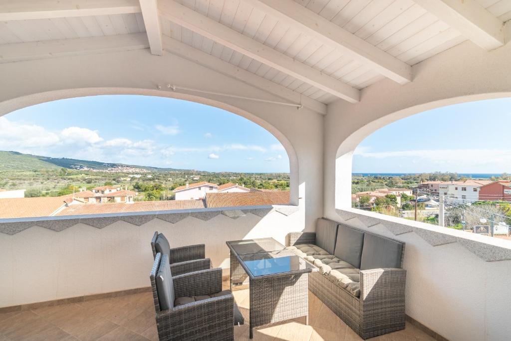 a balcony with two chairs and a table with a view at Attico con vista mare a Budoni in Budoni