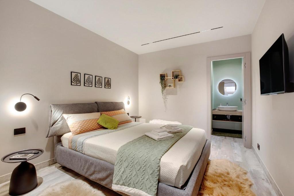 a bedroom with a large bed and a bathroom at Maison Bijoux Aosta in Aosta